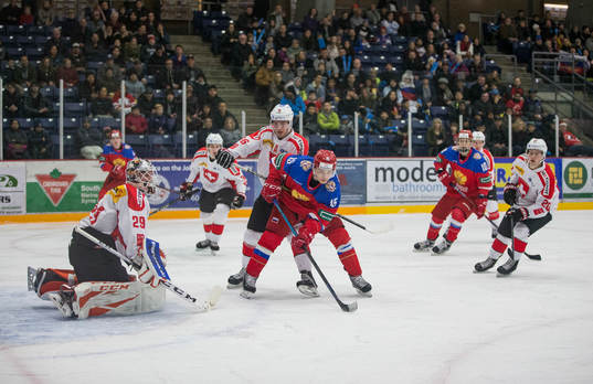 Switzerland defenceman Nico Gross (16)  battles with Russia