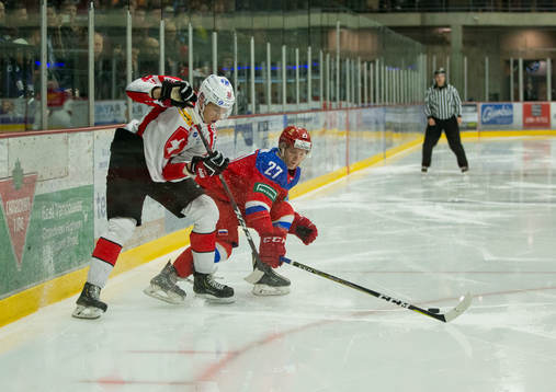 Russia defenceman Mark Rubinchik (27) checks Switzerland