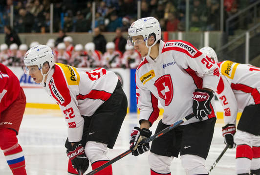 Switzerland forward Nando Eggenberger (22)  and  defenceman