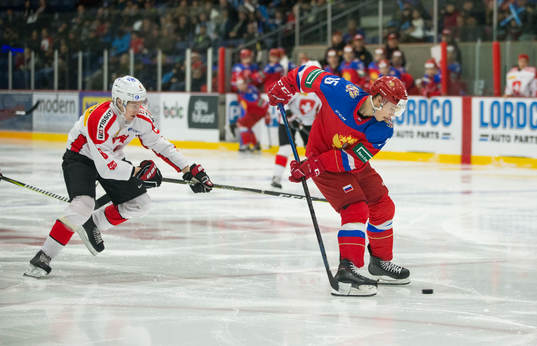 Switzerland defenceman Janis Moser (8) checks Russia