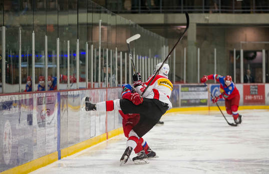Switzerland defenceman Nico Gross (16) checks Russia