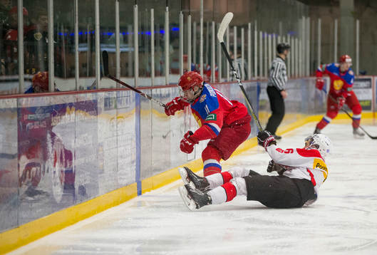 Switzerland defenceman Nico Gross (16) checks Russia