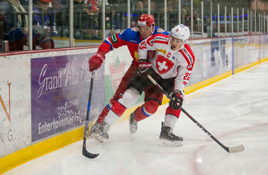 Russia defenceman Ilia Morozov (6)  battles with