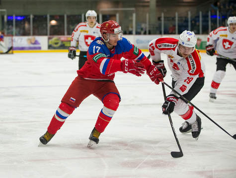 Switzerland defenceman Davyd Barandun (19)  checks Russia