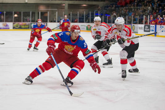 Switzerland defenceman Nico Gross (16)  checks Russia