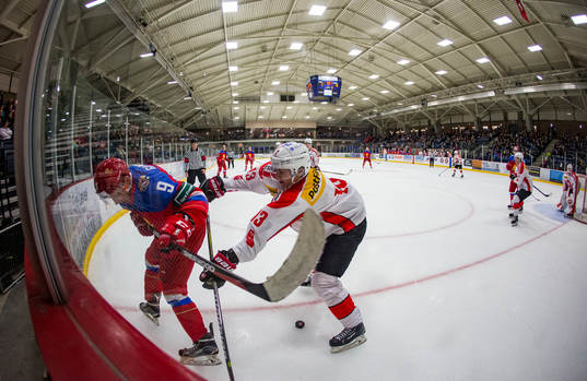 Switzerland forward Justin Sigrist (13) checks Russia