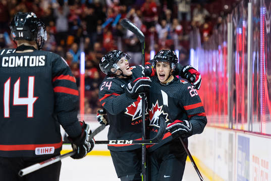 Ty Smith and Morgan Frost of Canada celebrate the 1-1 goal