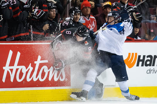 Cody Glass of Canada is being tackled by Eeli Tolvanen of