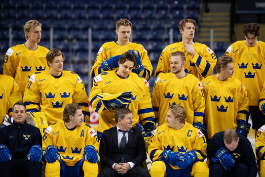 Goaltender Olle Eriksson Ek plays with team manager Jonas