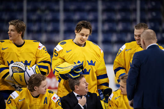 Goaltender Olle Eriksson Ek plays with team manager Jonas