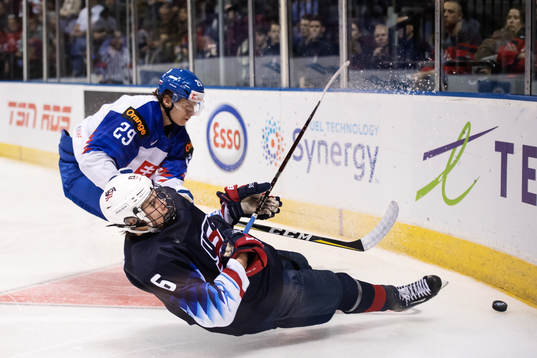 Jack Hughes of USA falls in action against Michal Ivan of