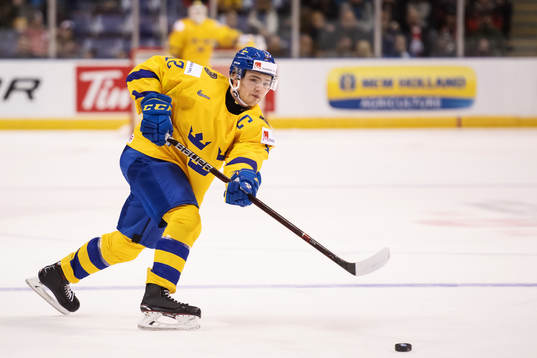 Erik Brännström of Sweden shoots the puck