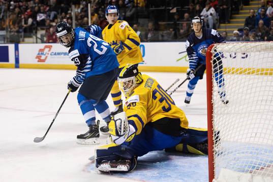 Anton Lundell of Finland in front of goaltender Samuel