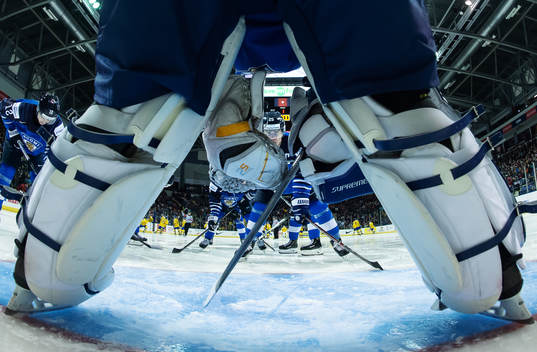 Aarne Talvitie of Finland is seen between the shin pads of