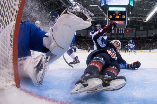 Team U.S.A.'s Jason Robertson crashes into Slovakia's