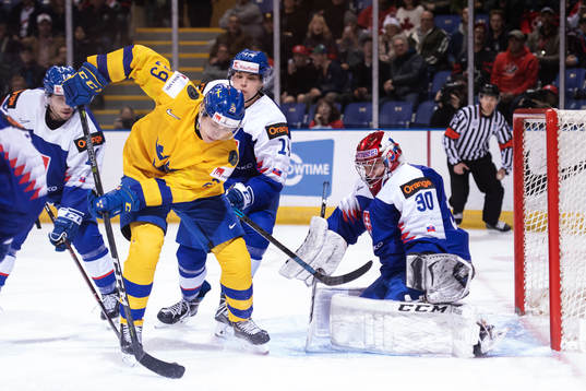 Pontus Holmberg of Sweden in front of goaltender Juraj