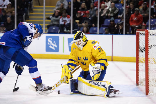 Milos Roman of Slovakia in action against goaltender Samuel