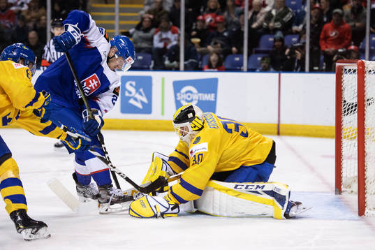 Milos Roman of Slovakia in action against goaltender Samuel