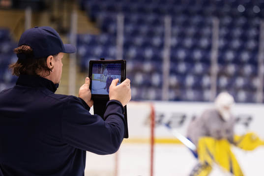 Goalie coach Nizze Landén of team Sweden films at a