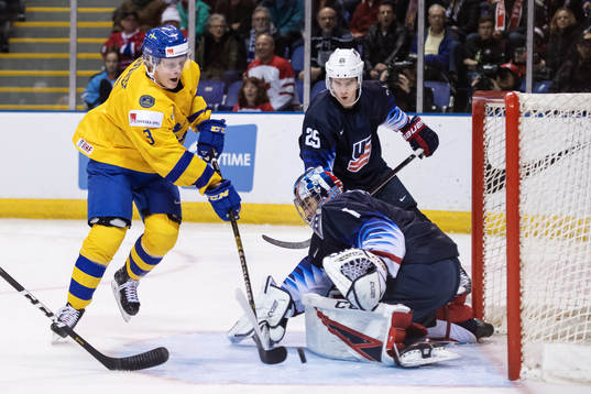 Adam Boqvist of Sweden in action against goaltender Kyle