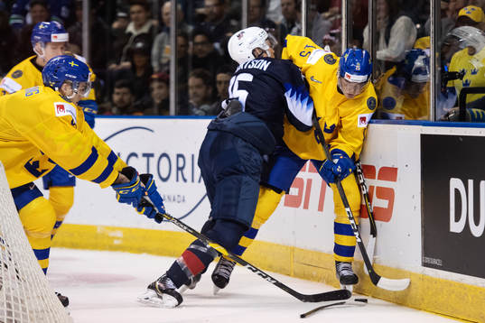 Jason Robertson of USA tackles Oskar Bäck of Sweden