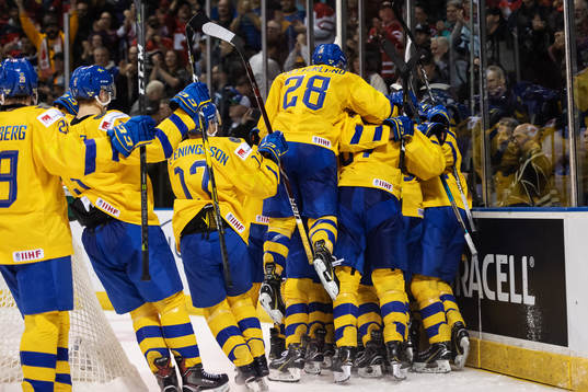Players of team Sweden celebrate the game winning 5-4 goal