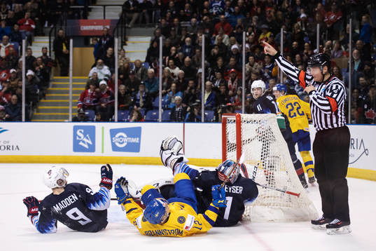 Tyler Madden and goaltender Kyle Keyser of USA and Erik
