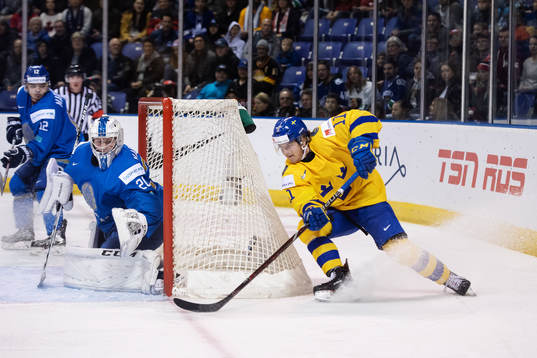 Goaltender Denis Karatayev of Kazakhstan and Samuel Fagemo