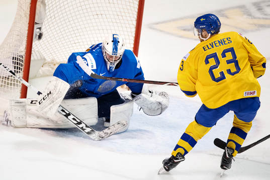 Goaltender Denis Karatayev of Kazakhstan makes a save