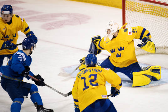 Goaltender Olle Eriksson Ek of Sweden makes a save