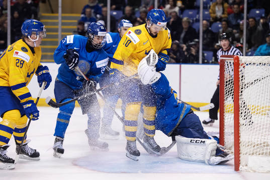 Emil Bemström of Sweden in action against goaltender Denis