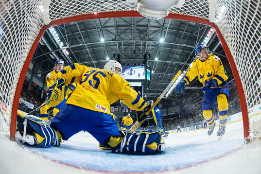 Filip Westerlund, goaltender Olle Eriksson Ek and Erik