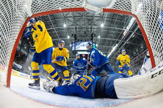 Goaltender Denis Karatayev of Kazakhstan stretches for the