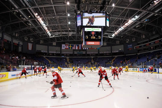 Players of team Switzerland and Sweden warm up