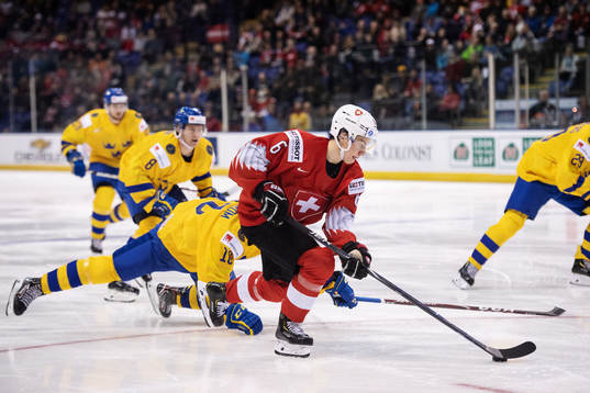Marco Lehmann of Switzerland dribbles past Lucas Elvenes of