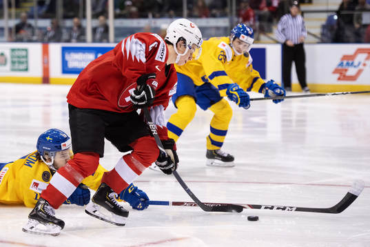 Marco Lehmann of Switzerland dribbles past Lucas Elvenes of