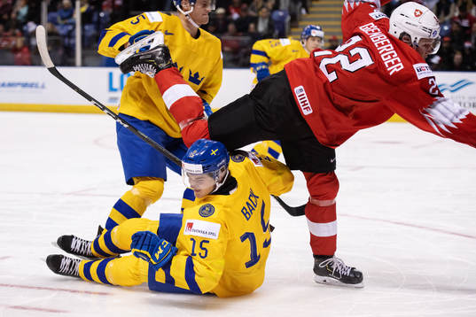 Oskar Bäck of Sweden is being tackled by Nando Eggenberger