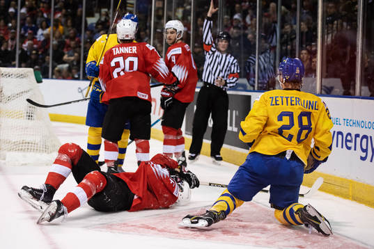 Fabian Zetterlund (R )of Sweden gets a penalty