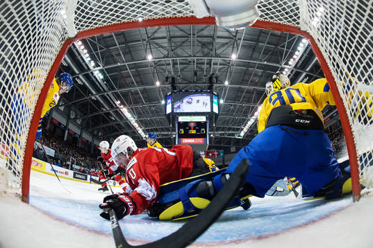 Ramon Tanner of Switzerland and goaltender Samuel Ersson of