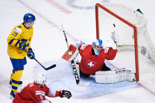 Pontus Holmberg of Sweden sees goaltender Luca Hollenstein