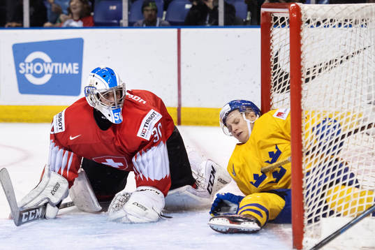 Goaltender Luca Hollenstein of Switzerland and Filip