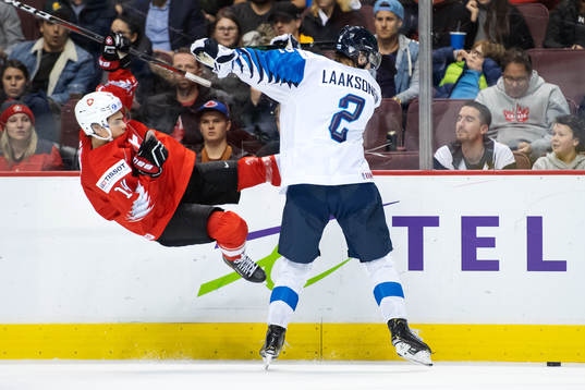 Sandro Schmid of Switzerland is being tackled by Oskari