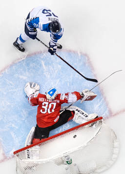 Aarne Talvitie of Finland scores 2-0 behind goaltender Luca