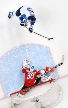 Aarne Talvitie of Finland scores 2-0 behind goaltender Luca