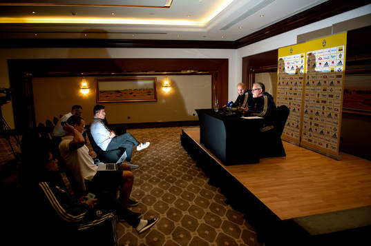 Swedish reporter Patrik Ekvall listens to Head coach Janne