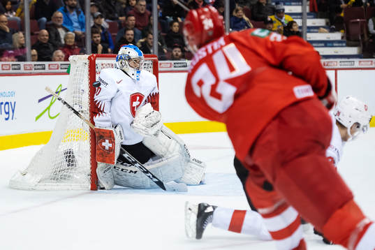 Goaltender Luca Hollenstein of Switzerland saves a shot