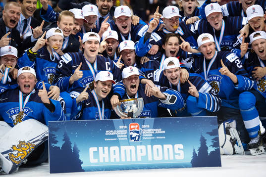 Players and coaching staff of Finland celebrate their win