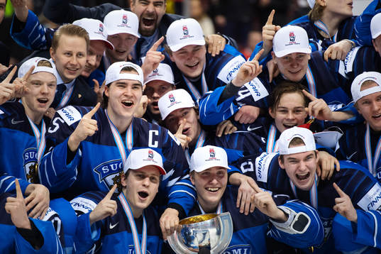 Players and coaching staff of Finland celebrate their win