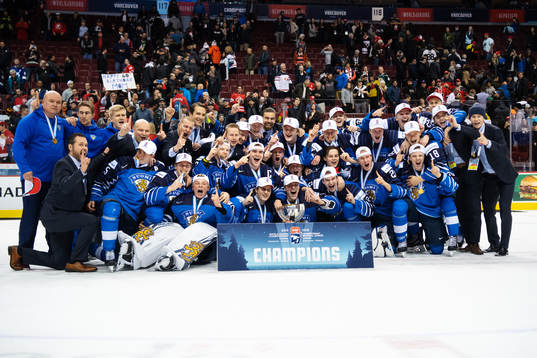 Players and coaching staff of Finland celebrate their win