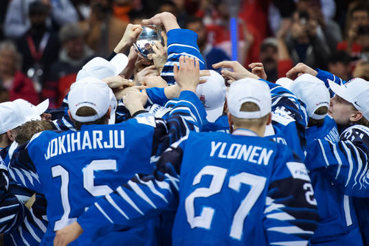 Players of Finland hoist the winner's trophy and celebrate